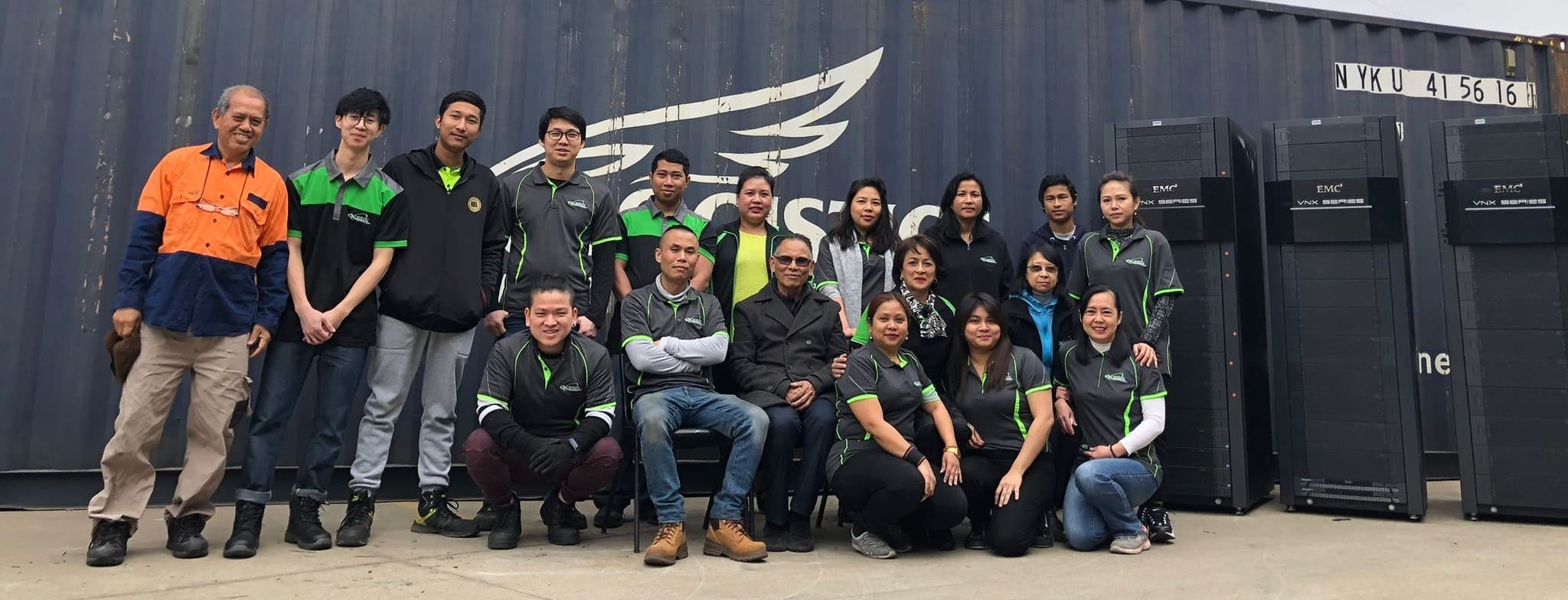 Excess Technology team with company vehicles and facility