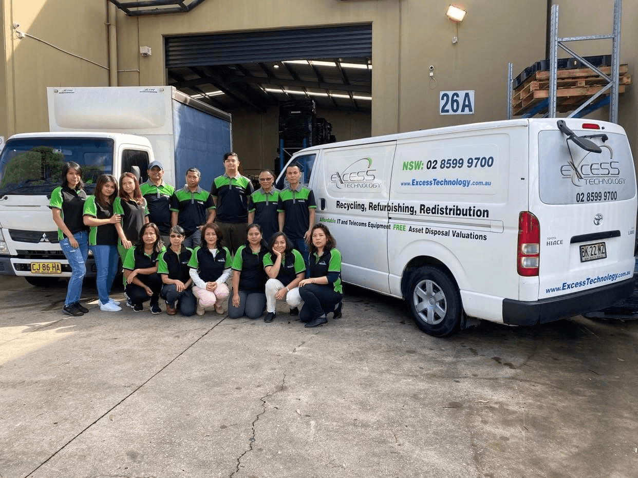 Excess Technology team with company vehicles and facility